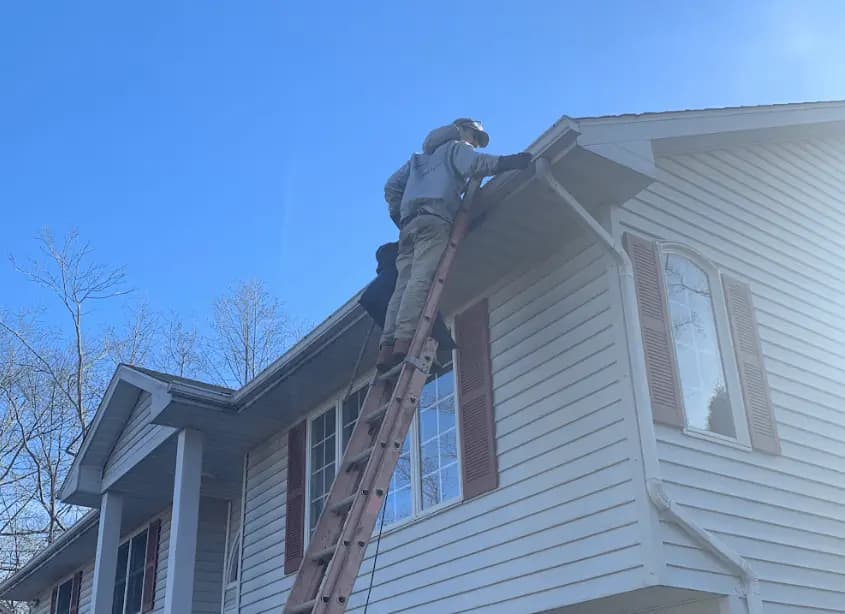 Gutter cleaning and maintenance being performed by South Euclid Power Washing in South Euclid